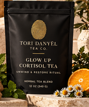 Glow Up Cortisol Tea black tea pouch with the gold Tori Danyël Tea Co. fingerprint branding, as shown in the collection photograph